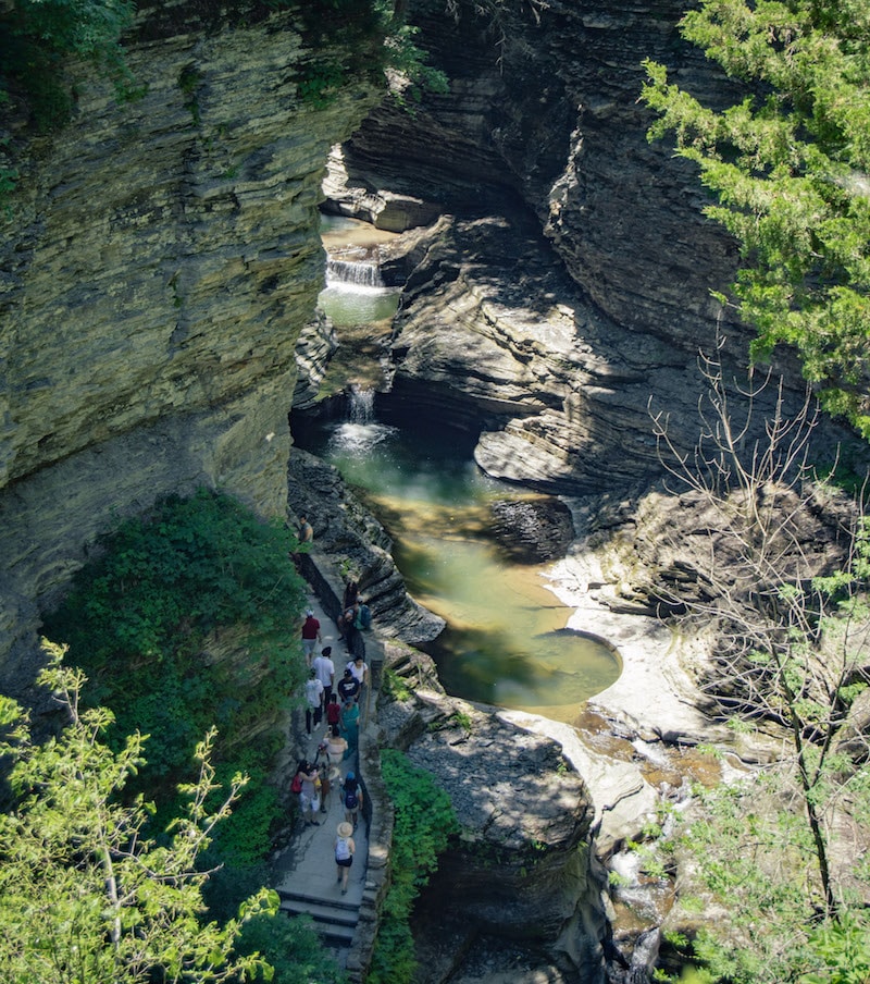 a birds-eye view of Watkins Glen. Looking down at people, small pools, and lots of rocks.