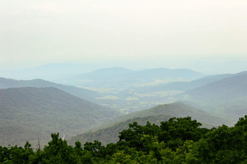the lush shenandoah valley, surrounded by the blue ridge mountains on a cloudy day